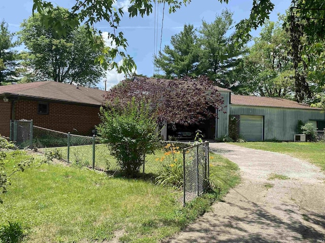 1802 Delphi Ave, Frankfort, IN 46041 - view of property exterior with driveway, a garage, and brick siding