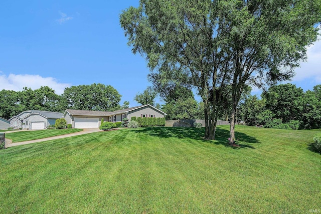 54410 Pleasant Valley Dr, Osceola, IN 46561 - view of yard featuring an attached garage and driveway