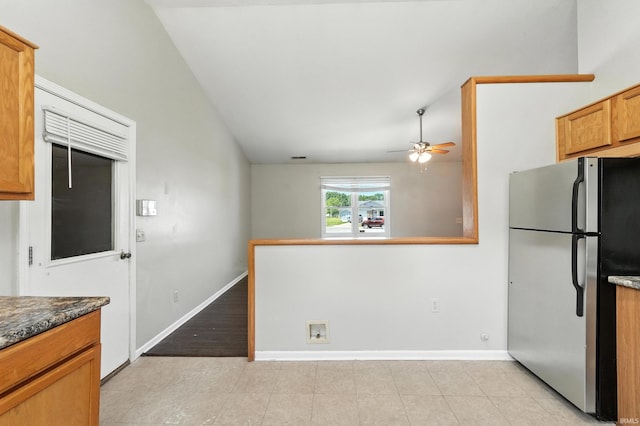 806 Deer Ridge Xing, Auburn, IN 46706 - kitchen featuring freestanding refrigerator, a ceiling fan, lofted ceiling, light tile patterned floors, and brown cabinetry
