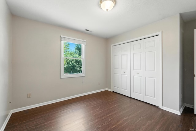 806 Deer Ridge Xing, Auburn, IN 46706 - unfurnished bedroom with dark wood-style floors and a closet