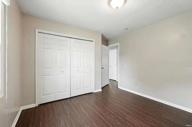 806 Deer Ridge Xing, Auburn, IN 46706 - unfurnished bedroom with dark wood-type flooring and a closet