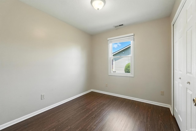 806 Deer Ridge Xing, Auburn, IN 46706 - unfurnished bedroom with a closet and dark wood finished floors