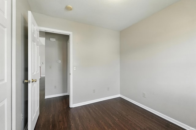 806 Deer Ridge Xing, Auburn, IN 46706 - unfurnished room with dark wood-type flooring and a smoke detector