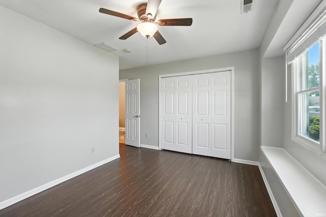 806 Deer Ridge Xing, Auburn, IN 46706 - unfurnished bedroom with dark wood-style floors, multiple windows, a closet, and a ceiling fan