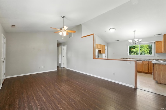 806 Deer Ridge Xing, Auburn, IN 46706 - unfurnished living room featuring wood finished floors, a chandelier, a ceiling fan, and vaulted ceiling
