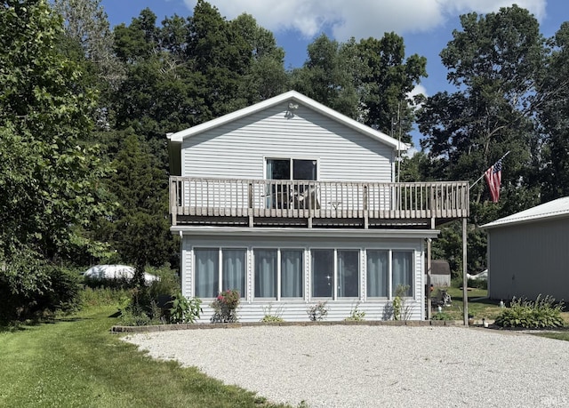 1074 Chapman Lake Dr, Warsaw, IN 46582 - rear view of house featuring a balcony and a lawn