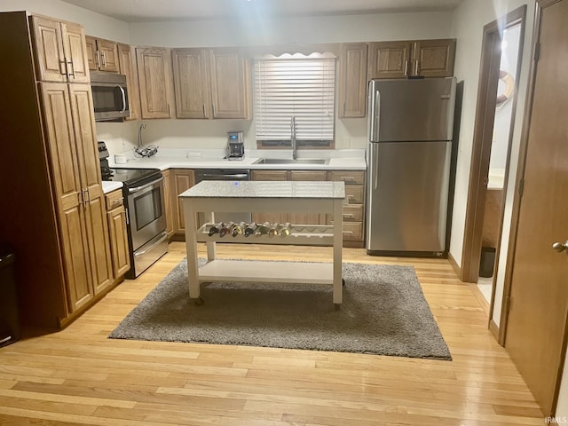 1074 Chapman Lake Dr, Warsaw, IN 46582 - kitchen with stainless steel appliances, light wood-style floors, and light countertops