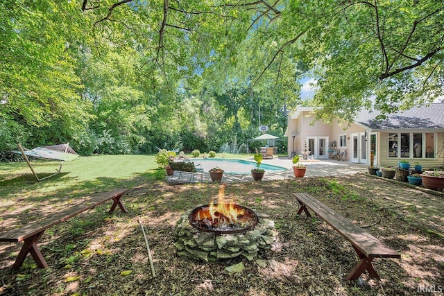 1760 Grant St, Elkhart, IN 46514 - view of yard with french doors, an outdoor fire pit, an outdoor pool, and a patio area