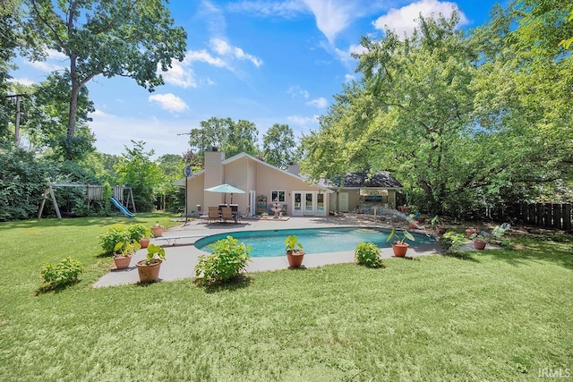1760 Grant St, Elkhart, IN 46514 - swimming pool featuring a patio area, a playground, and french doors