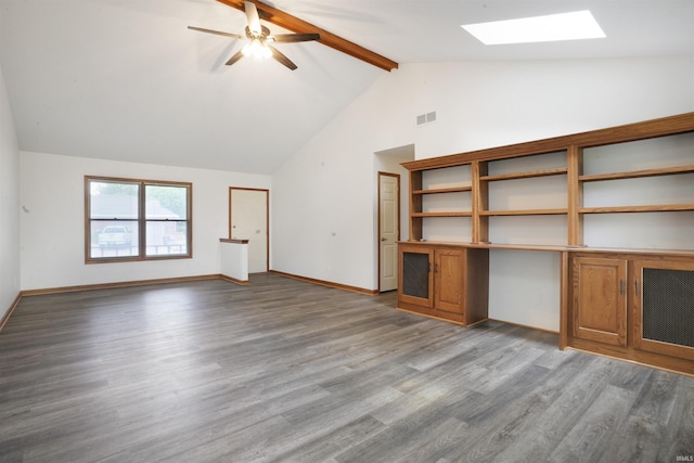 741 Christopher Dr, Evansville, IN 47711 - unfurnished living room with a skylight, beamed ceiling, wood finished floors, a ceiling fan, and high vaulted ceiling