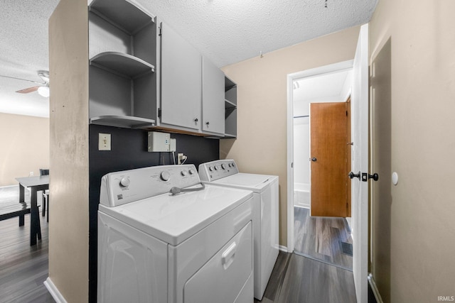 6701 Bittersweet Dr, Fort Wayne, IN 46825 - washroom featuring cabinet space, independent washer and dryer, a textured ceiling, dark wood-style floors, and a ceiling fan