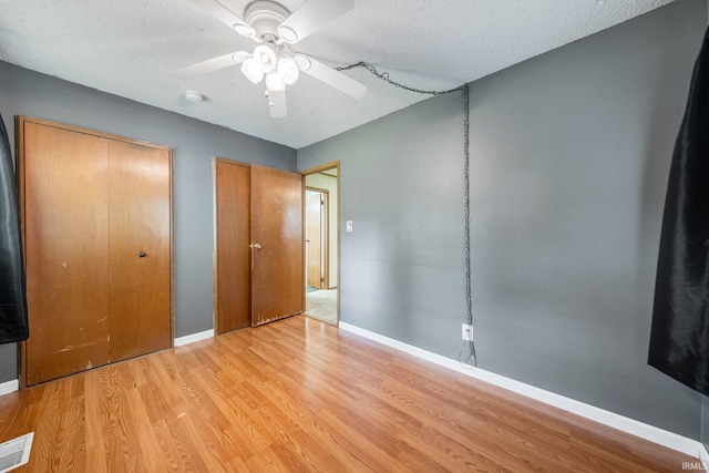 6701 Bittersweet Dr, Fort Wayne, IN 46825 - unfurnished bedroom featuring light wood-style flooring, a textured ceiling, and a ceiling fan