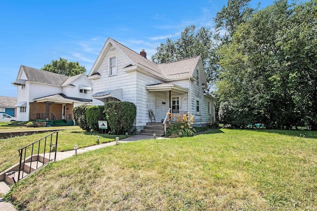 517 S Kaley St, South Bend, IN 46619 - view of front facade featuring a front yard, a chimney, and roof with shingles