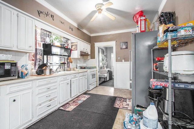 517 S Kaley St, South Bend, IN 46619 - kitchen with white range with gas cooktop, freestanding refrigerator, ceiling fan, crown molding, and under cabinet range hood