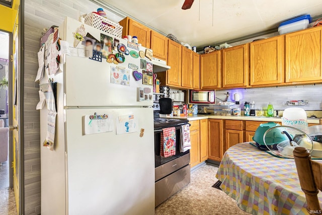 746 S Albert Ave, South Bend, IN 46619 - kitchen with stainless steel appliances, light countertops, extractor fan, ceiling fan, and brown cabinetry