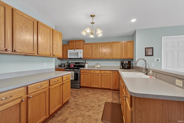 5506 Getty Ct, Granger, IN 46530 - kitchen with white microwave, gas stove, a peninsula, a chandelier, and hanging light fixtures
