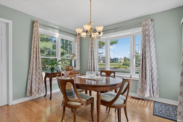 5506 Getty Ct, Granger, IN 46530 - dining room featuring a chandelier, healthy amount of natural light, and light wood-style floors
