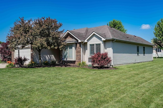 10414 Unita Dr, Fort Wayne, IN 46804 - view of front of house with an attached garage, a front yard, and a shingled roof