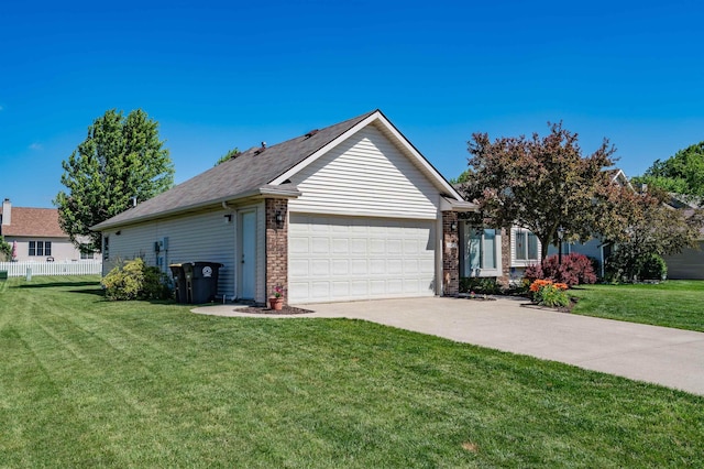 10414 Unita Dr, Fort Wayne, IN 46804 - view of property exterior featuring an attached garage, driveway, a yard, and brick siding