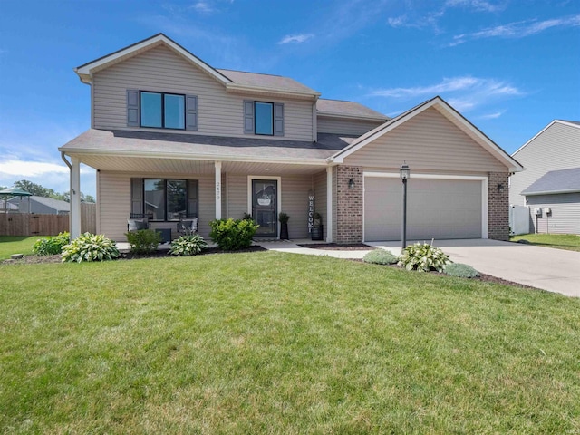 2479 Trillium Cv, Huntertown, IN 46748 - view of front of house featuring a garage, driveway, covered porch, and brick siding