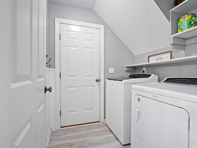 2479 Trillium Cv, Huntertown, IN 46748 - washroom featuring a textured ceiling, independent washer and dryer, and light wood finished floors