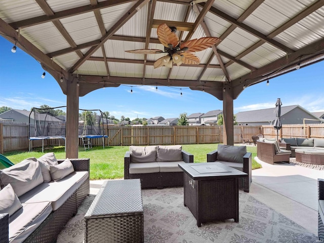 2479 Trillium Cv, Huntertown, IN 46748 - fenced backyard featuring a trampoline, an outdoor living space with a fire pit, a gazebo, a patio area, and a residential view