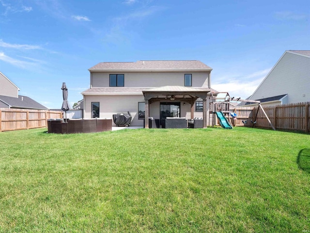 2479 Trillium Cv, Huntertown, IN 46748 - back of property with an outdoor hangout area, a fenced backyard, a playground, and a patio