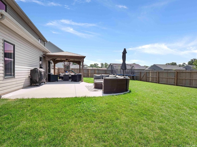 2479 Trillium Cv, Huntertown, IN 46748 - fenced backyard with an outdoor living space, a gazebo, a patio area, and a trampoline