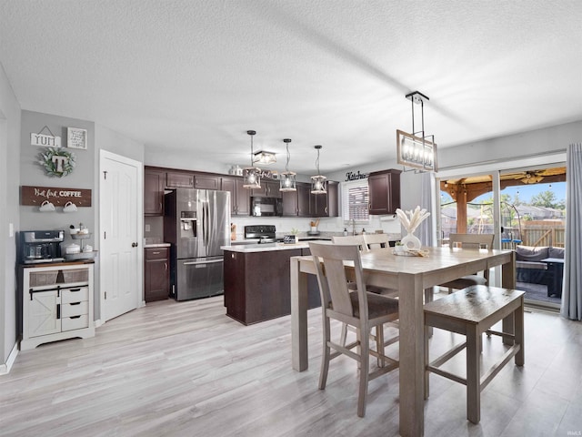 2479 Trillium Cv, Huntertown, IN 46748 - dining space featuring a textured ceiling, light wood-style floors, and a chandelier