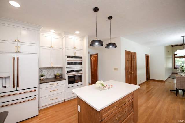 3827 Sunnycroft Pl, West Lafayette, IN 47906 - kitchen with white appliances, light wood-type flooring, pendant lighting, white cabinetry, and recessed lighting
