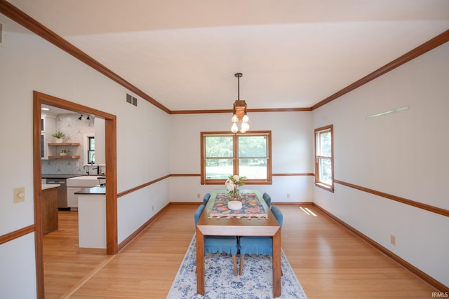 3827 Sunnycroft Pl, West Lafayette, IN 47906 - dining space with light wood-type flooring, a chandelier, and crown molding