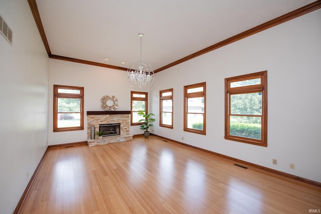 3827 Sunnycroft Pl, West Lafayette, IN 47906 - unfurnished living room featuring a chandelier, crown molding, healthy amount of natural light, light wood-type flooring, and a stone fireplace