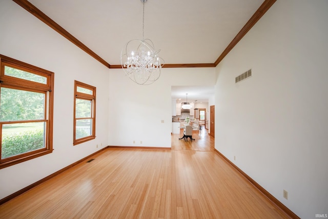 3827 Sunnycroft Pl, West Lafayette, IN 47906 - unfurnished room with a chandelier, light wood finished floors, ornamental molding, and a towering ceiling