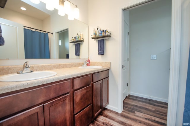 6471 Wallingford St, Lafayette, IN 47905 - bathroom featuring wood finished floors, double vanity, recessed lighting, and curtained shower