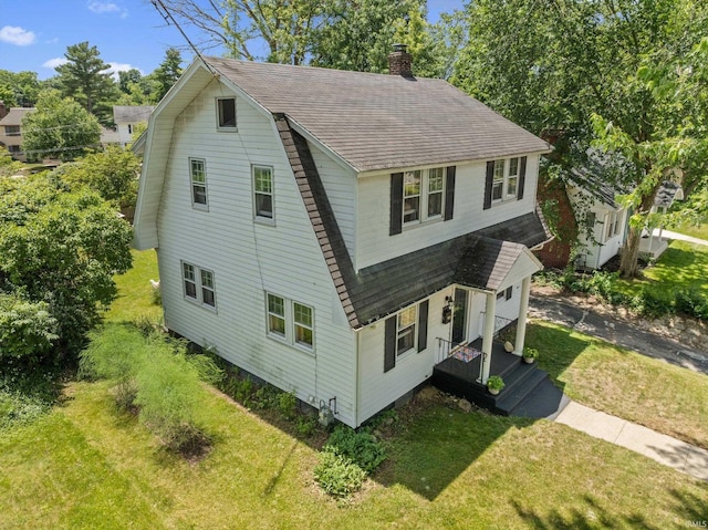 412 Tonti Ave, South Bend, IN 46617 - view of side of home with roof with shingles, a chimney, a gambrel roof, and a lawn