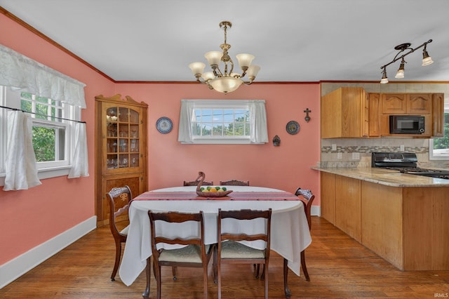 412 Tonti Ave, South Bend, IN 46617 - dining space featuring a chandelier, plenty of natural light, wood finished floors, and ornamental molding