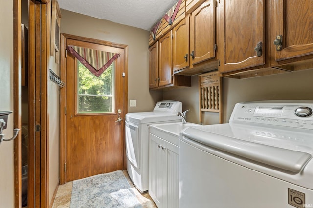 51769 S Saddle Ridge Ln, Granger, IN 46530 - washroom featuring separate washer and dryer, cabinet space, and a textured ceiling