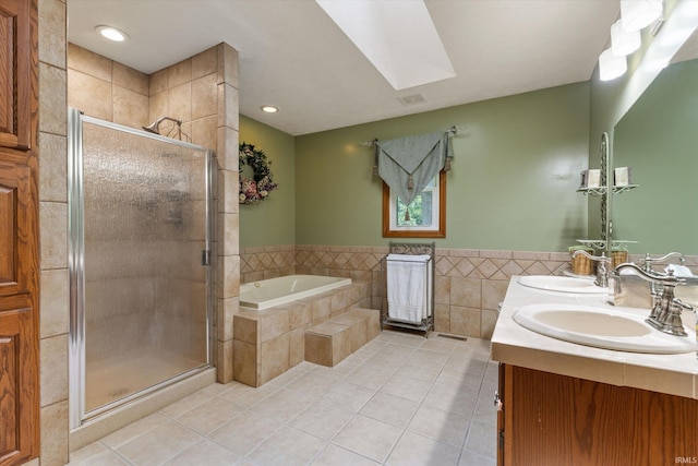 51769 S Saddle Ridge Ln, Granger, IN 46530 - bathroom with tile patterned flooring, a bath, a stall shower, double vanity, and a skylight
