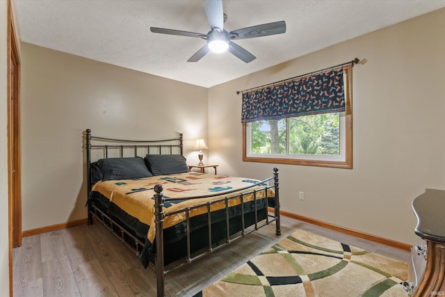 51769 S Saddle Ridge Ln, Granger, IN 46530 - bedroom featuring wood finished floors, ceiling fan, and a textured ceiling