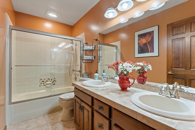 51769 S Saddle Ridge Ln, Granger, IN 46530 - bathroom featuring double vanity, bath / shower combo with glass door, and tile patterned flooring