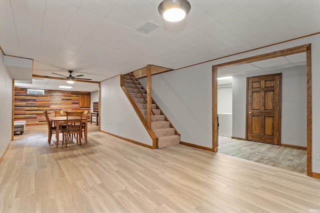 51769 S Saddle Ridge Ln, Granger, IN 46530 - unfurnished dining area with light wood-style flooring, stairway, and ceiling fan