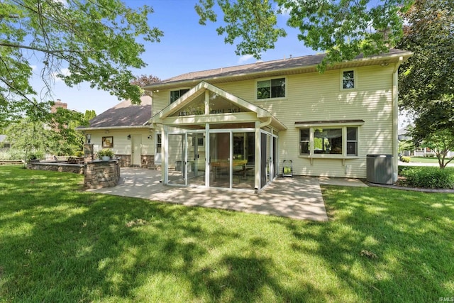 51769 S Saddle Ridge Ln, Granger, IN 46530 - back of property with a patio, a sunroom, and a lawn