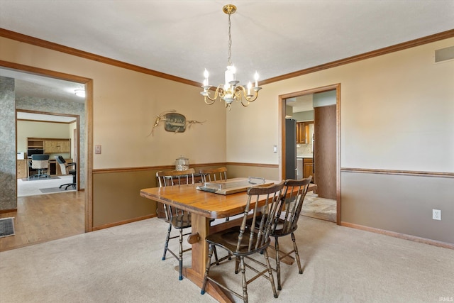 51769 S Saddle Ridge Ln, Granger, IN 46530 - dining space featuring a chandelier, ornamental molding, and light carpet