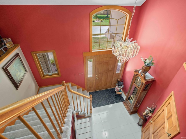 6709 Shag Bark Ct, Fort Wayne, IN 46835 - tiled foyer entrance featuring stairway, a chandelier, and a high ceiling