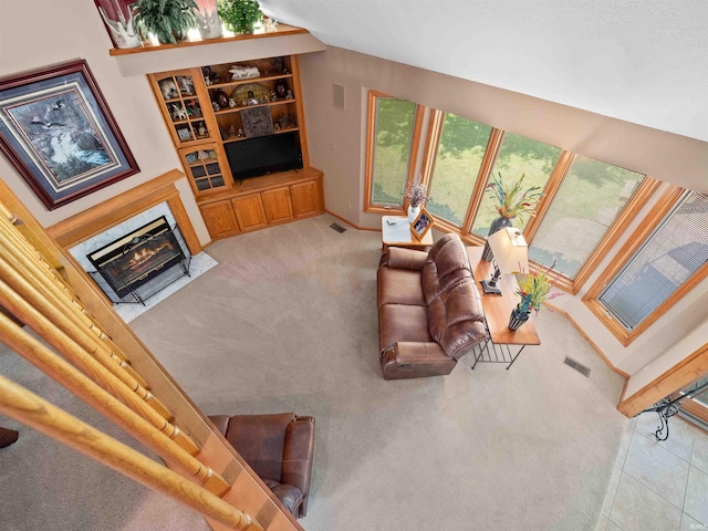 6709 Shag Bark Ct, Fort Wayne, IN 46835 - carpeted living room featuring a fireplace with flush hearth and built in features