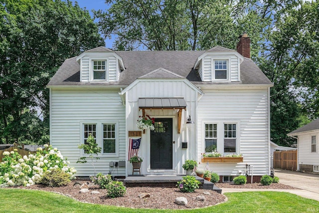 1521 E Beardsley Ave, Elkhart, IN 46514 - view of front of home with a chimney, board and batten siding, and roof with shingles