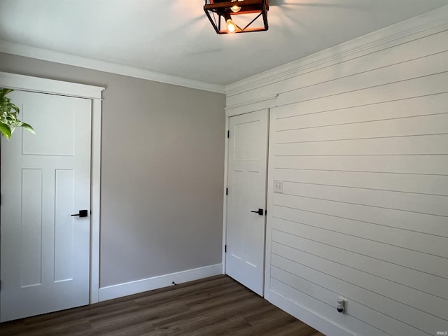 1503 W Ave, Goshen, IN 46526 - unfurnished bedroom featuring dark wood-style floors and ornamental molding