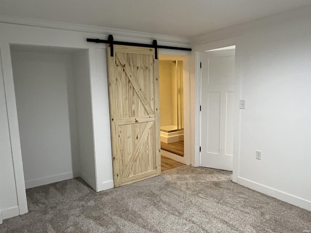 1503 W Ave, Goshen, IN 46526 - unfurnished bedroom featuring carpet flooring and a barn door