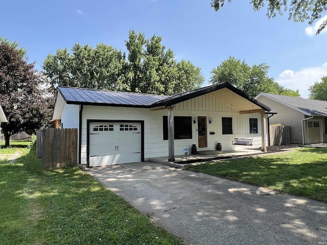 1503 W Ave, Goshen, IN 46526 - ranch-style home with an attached garage, a standing seam roof, driveway, a metal roof, and board and batten siding