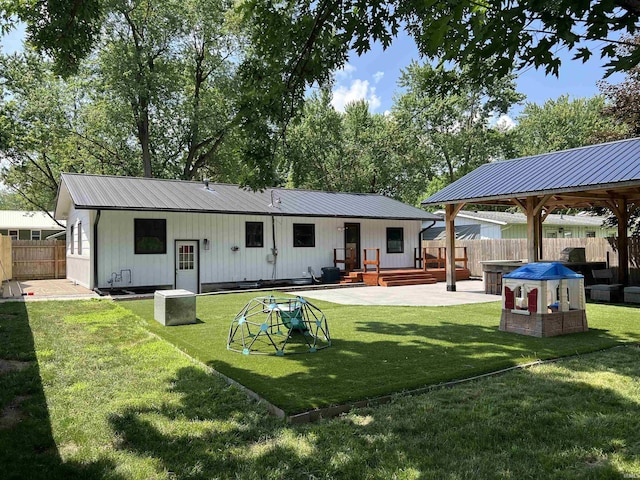1503 W Ave, Goshen, IN 46526 - rear view of property featuring a metal roof, a fenced backyard, and a patio